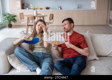 Fatigued of heat wife and exhausted husband feeling unwell due to absence of ventilator, conditioner Stock Photo