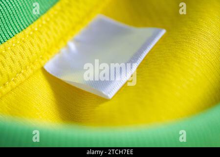 clothes label on sport textile football shirt background Stock Photo