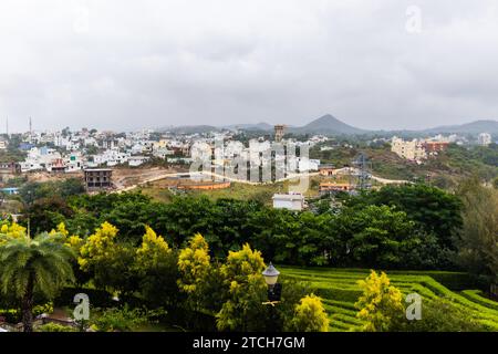 city at the foothill of misty mountain layer at morning from flat angle Stock Photo