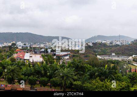 city at the foothill of misty mountain layer at morning from flat angle Stock Photo