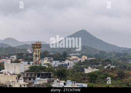 city at the foothill of misty mountain layer at morning from flat angle Stock Photo