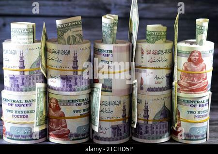 Piles and bundles of Egypt money  thousands of Pounds currency banknotes bills rolls of 200 EGP LE, Egyptian money exchange rate and USA American doll Stock Photo