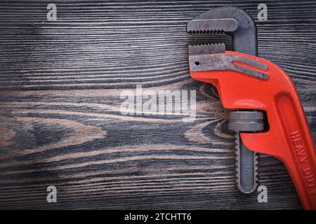 Adjustable pipe wrench on wooden board Copy room sanitary concept Stock Photo