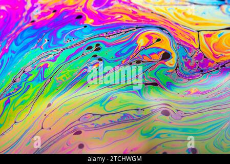 Abstract background made from soap bubble reflecting light. Rainbow soap bubble on a dark background Stock Photo