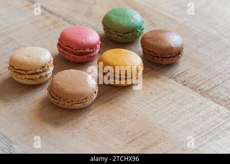Traditional french colorful macarons in a row on table. Colorful cookies Stock Photo