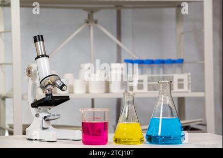 Erlenmeyer flask and beaker with microscope and liquid Stock Photo