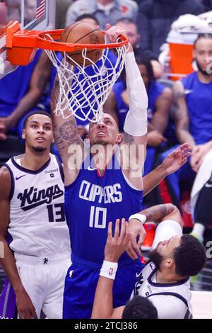 Los Angeles, United States. 12th Dec, 2023. Los Angeles Clippers' Daniel Theis (C) dunks against the Sacramento Kings during an NBA basketball game at Crypto.com Arena. Final scores: Clippers 119:98 Kings. Credit: SOPA Images Limited/Alamy Live News Stock Photo