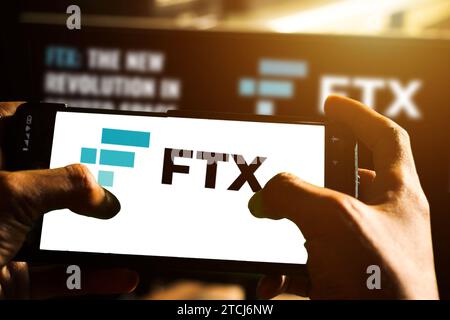 pringsewu, Lampung; December 14, 2023; Boy holding smartphone with logo of cryptocurrency exchange company FTX Trading on screen in front of website. Stock Photo