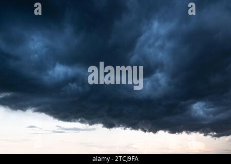 Light in the Dark and Dramatic Storm Clouds background Stock Photo