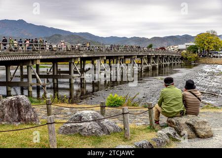 KYOTO/JAPAN - November 27, 2023:View of the busy Togetsukyo Bridge in Kyoto Stock Photo