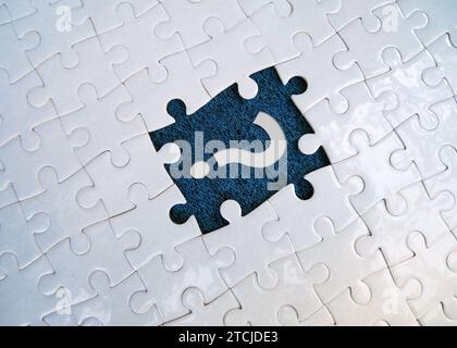 Question mark on jigsaw puzzle with missing piece. Concept of question, FAQ, Q and A, confusion and solution. Stock Photo