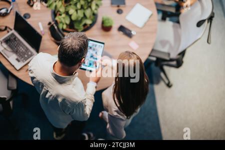 Business leaders discussing efficiency, ideas, and work results. Collaboration, teamwork, and technology drive success in this corporate setting. Stock Photo