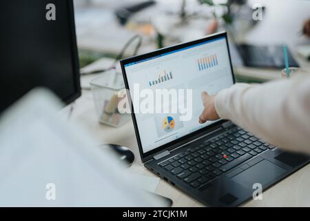 Multiracial Business Team Collaborating on Market Analysis and Strategic Planning in Corporate Office Setting Stock Photo