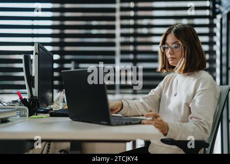Diverse professionals collaborate on business strategies and market analysis in a modern office setting. Stock Photo