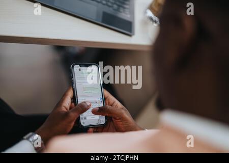 Male employee chatting on social media with friends while taking a break from work. Close up photo. Stock Photo