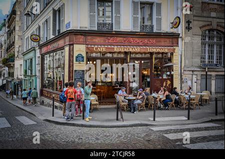 Paris, France July 1, 2022. Le Progres cafe is a traditional French cafe in the Montmartre neighborhood. Full of Parisian charm, people stop in front, Stock Photo