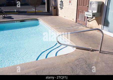 Grab bars ladder in the swimming pool, outdoor Stock Photo