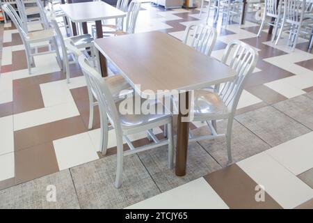 Set of modern silver wooden table and chairs in the restaurant Stock Photo