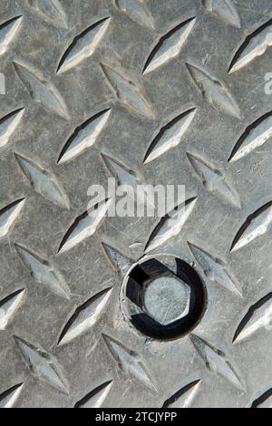 Metal diamond plate pattern and background seamless, grunge diamond metal plate with screw Stock Photo