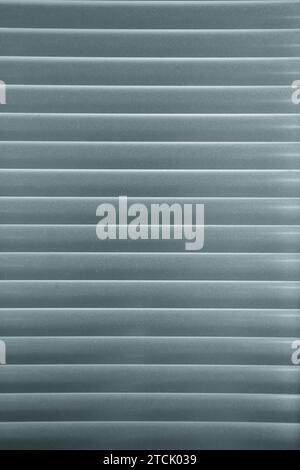 Horizontal pattern of grey venetian blinds in a gradation of color Stock Photo
