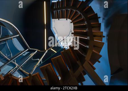 View to the top of the curved staircase from its bottom Stock Photo