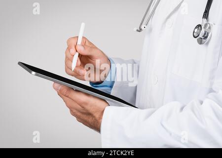 Doctor using a digital tablet with stylus pen, closeup Stock Photo