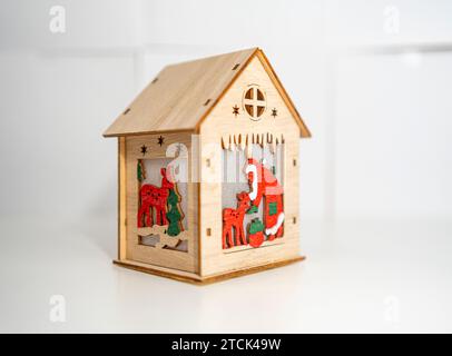 Small cabin with Santa feeding reindeer Stock Photo