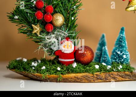 Small Santa decoration next to Christmas trees Stock Photo