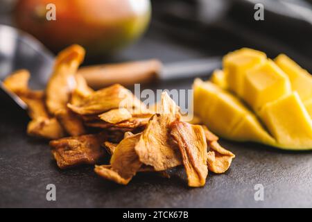 Dried mango fruit on the black table. Stock Photo