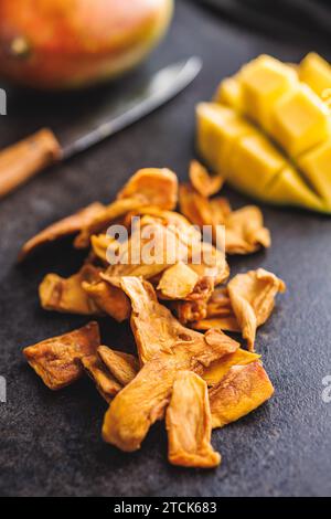 Dried mango fruit on the black table. Stock Photo