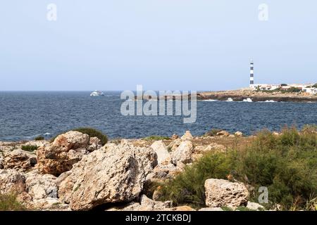 Coastline with the lighthouse of Cap d'Artrutx near the town of Cala en Bosch in the southwest of the Spanish island of Minorca. Stock Photo