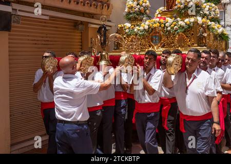 Statue of Saint Bernard on the float being carried into the church in the Romeria San Bernabe; Marbella, Costa del Sol, Malaga Province, Andalusia. Stock Photo