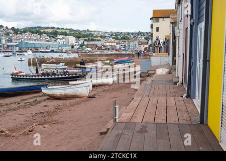 Teignmouth, England – July 21, 2023: View of the beach adjoining the harbour, with the historic passenger ferry to nearby Shaldon waiting to depart Stock Photo