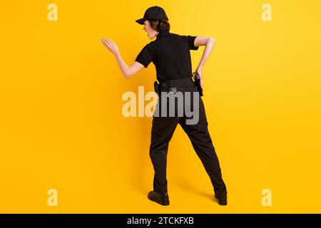 Full length rear portrait of furious lady look direct arm empty space isolated on yellow color background Stock Photo