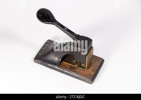 perfin stamp device used to prevent employees stealing postage stamps isolated on white studio background Stock Photo