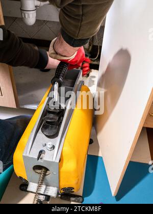 plumber cleaning sewer pipe in village house with drain cleaning machine Stock Photo