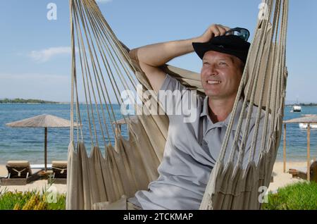 Smiling man in gomak with sea in background Stock Photo