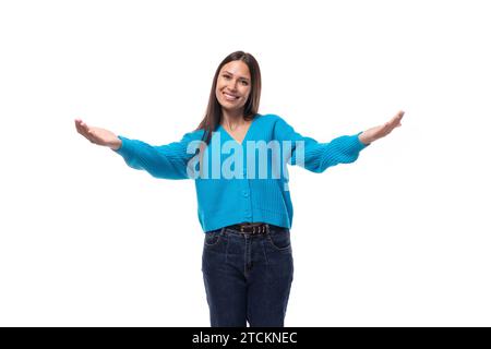 inspired successful cute young woman dressed in blue cardigan Stock Photo