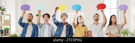 Group of multiracial people taking part in opinion survey and showing speech bubbles Stock Photo