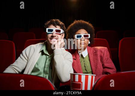cheerful multicultural young couple in retro 3d glasses having great time at cinema on their date Stock Photo