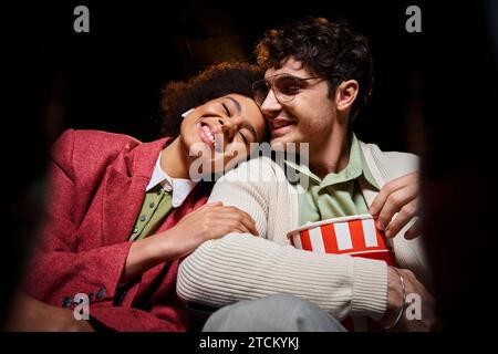 attractive cheerful multicultural couple having great time at cinema on date, Valentines day Stock Photo