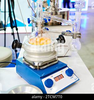 Laboratory heated stirrer and block heat resistant handles and flask Stock Photo