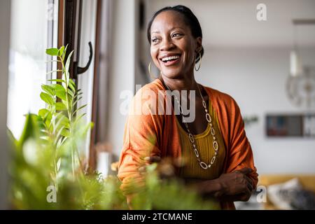 Portrait of a smiling mature woman standing in her apartment Stock Photo