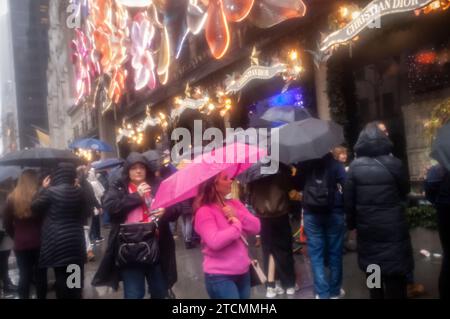 Thousands of tourists and New Yorkers view the Saks Fifth Avenue Christmas display during the Holiday Open Streets on Sunday, December 3, 2023. New York City closed a nine-block stretch of Fifth Avenue in Midtown to vehicles for four Sundays in December creating a holiday block party for visitors. (© Richard B. Levine) Stock Photo