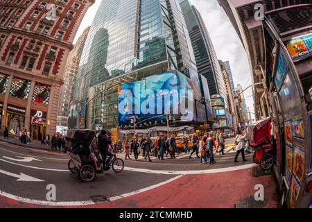 Hordes of people cross West 42nd Street under advertising for the Warner Bros. Pictures’  “Aquaman, The Lost Kingdom” film in Times Square in New York on Saturday, December 2, 2023. The film is slated to be released December 22 and is part of DC Comics’ franchises. (© Richard B. Levine) Stock Photo