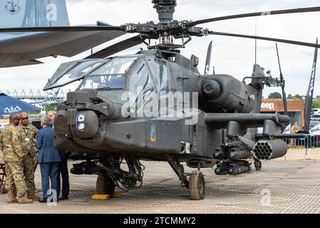 Boeing AH-64 Apache gunship helicopter, weapons & sensors with US personnel and business people at Farnborough International Airshow 2018. Arms trade Stock Photo