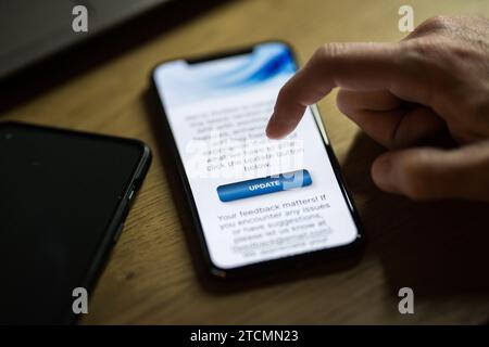 Clicking on update button on smartphone app Stock Photo