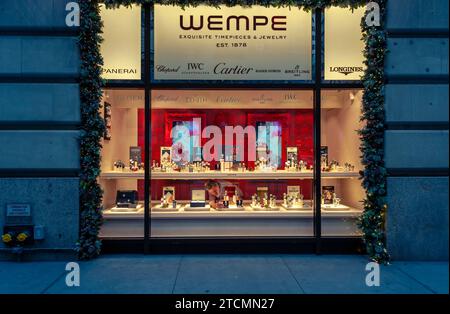 A worker adjusts the watches in the Christmas themed window display of the Wempe store in Midtown Manhattan in New York on Sunday, December 10, 2023. (© Richard B. Levine) Stock Photo