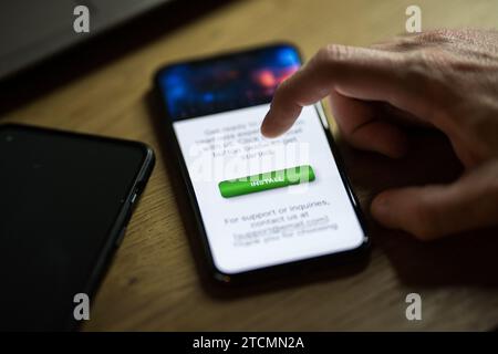 Clicking on green install button on smartphone Stock Photo