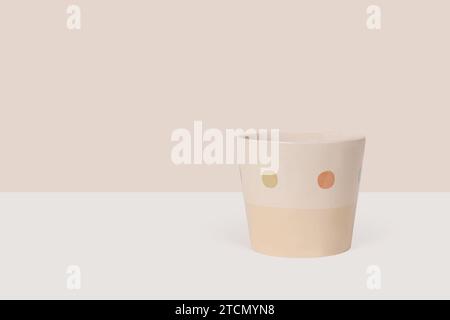 Beige empty ceramic flower pot isolated on light beige background Stock Photo